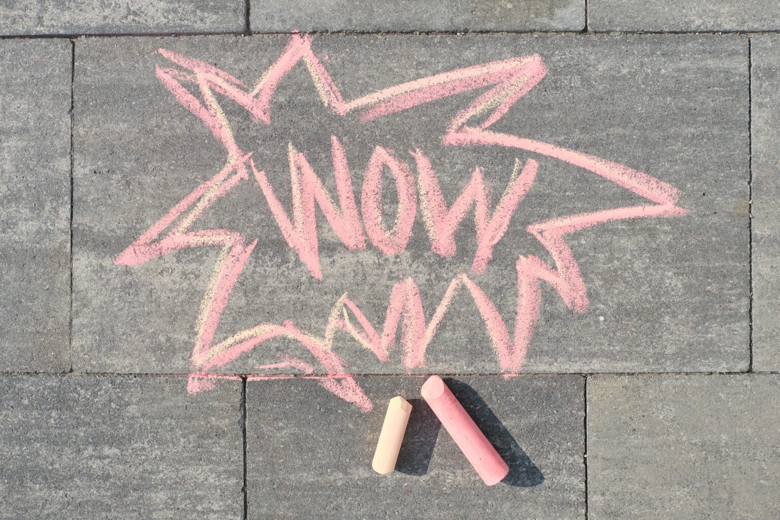 Wow written on gray sidewalk, top view